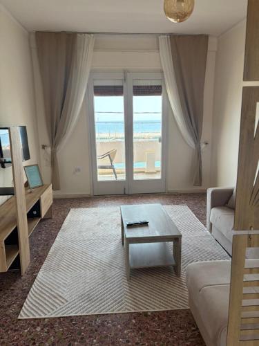 a living room with a couch and a coffee table at SMYRNA HOMES ASTRONOMi in Chios