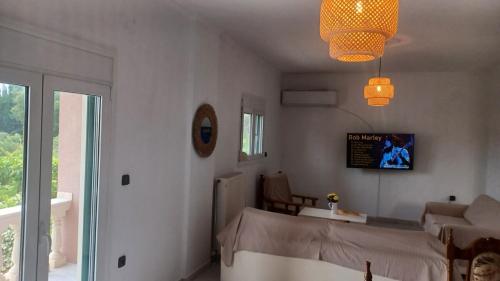 a bedroom with a bed and a living room at family home in Kanálion
