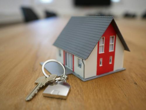 a small model of a house with a pair of keys at Rooms in Vienna