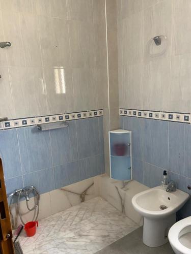 a bathroom with a toilet and a sink at Ksar Family House in Ksar es Sghir