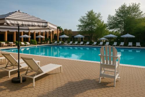 a pool with chairs and umbrellas next to at Solomons Inn Resort and Marina in Solomons