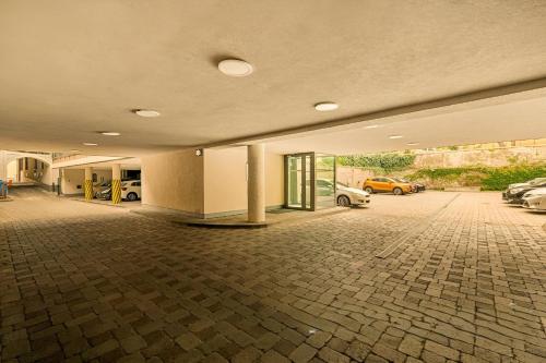 an empty parking lot with cars parked in a garage at P23 Apartments in Bratislava