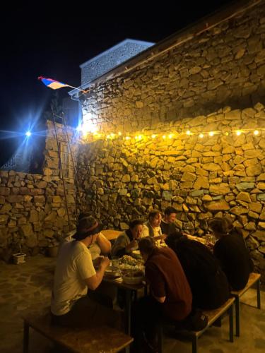 a group of people sitting at a table eating food at Khachats Toun Heritage in Meghri