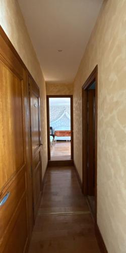 a hallway with a view of a room with a couch at Manoir Des Douets Fleuris in Cancale
