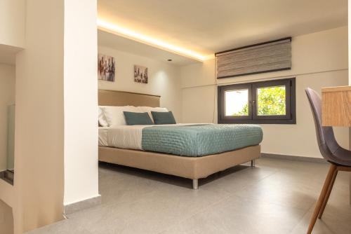 a bedroom with a bed and a window at Ikaros City Loft in Chania Town