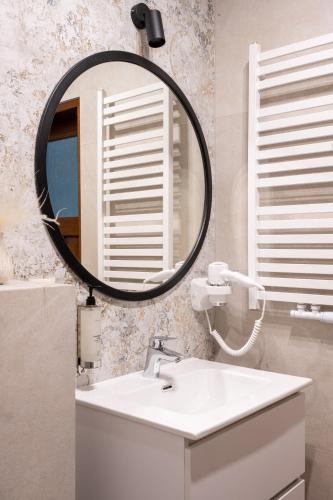 a bathroom with a sink and a mirror at Hotel Willa Pod Skocznią in Zakopane