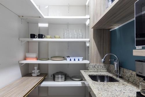 a kitchen with a sink and a counter top at New Studio Centro Florianópolis Centro Sul Eventos Praça XV in Florianópolis