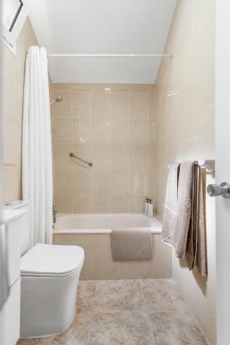 a bathroom with a toilet and a bath tub at Home2Book Relaxing Stay & Terrace in Maspalomas in Maspalomas