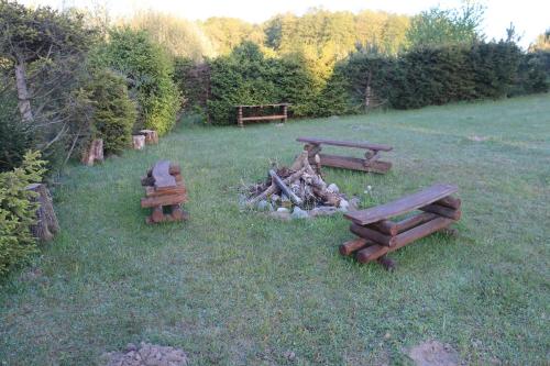 a park with benches and a fire in the grass at Dobrogoszcz in Dobrogoszcz