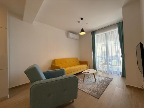 a living room with a couch and a chair at JUSE Seaside Retreat - Wake Up to the Adriatic Blue in Rafailovici