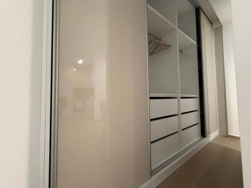 a walk in closet with a glass door at JUSE Seaside Retreat - Wake Up to the Adriatic Blue in Rafailovici