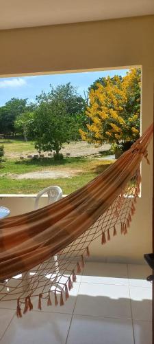 a hammock in a room with a window at Pousada Pedra do Sossego in Triunfo