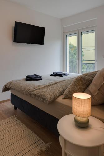 a bedroom with a bed with a television on the wall at Vila Dara in Vrnjačka Banja