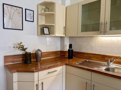 a kitchen with white cabinets and a sink at Gassentraum NEU mit Balkon in Pirna