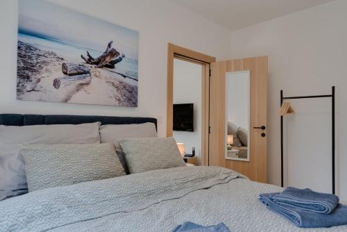 a bedroom with a bed with a picture on the wall at Vila Dara in Vrnjačka Banja