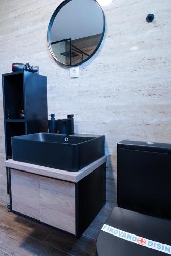 a bathroom with a black sink and a mirror at Vila Dara in Vrnjačka Banja