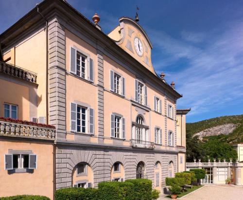 a building with a clock tower on top of it at Bagni Di Pisa Palace & Thermal Spa - The Leading Hotels of the World in San Giuliano Terme
