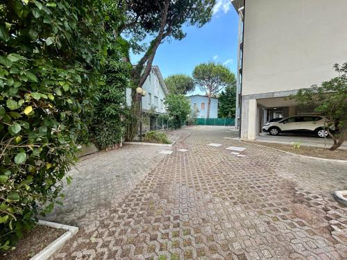 a cobblestone street in front of a house at Residence Rivaverde in Marina di Ravenna