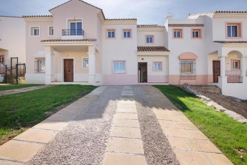 a large villa with a driveway in front of it at Estrella in Ayamonte