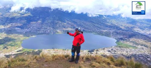 a man standing on top of a mountain at Green House Araque Inn in Otavalo