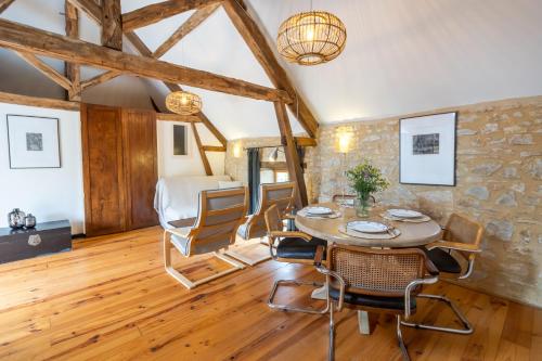 a dining room with a table and chairs at Maison Salle de Musique in La Forge-dʼAns