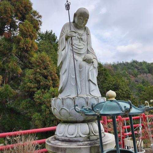 a statue of a god in a garden at Picturesque Kyoto in Habu