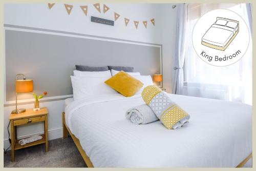 a bedroom with a white bed with two pillows on it at Enjoy the Pause Holiday Home, Chester in Chester