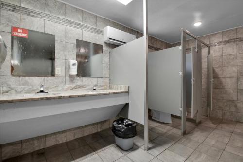 a public bathroom with two sinks and a shower at Studio Cabin with Loft near Smoky Mountains in Pigeon Forge