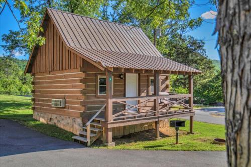 a log cabin with a metal roof at Studio Cabin with Loft near Smoky Mountains in Pigeon Forge
