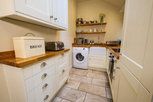 a kitchen with a washer and dryer at Craigendarroch No 1 in Acharn