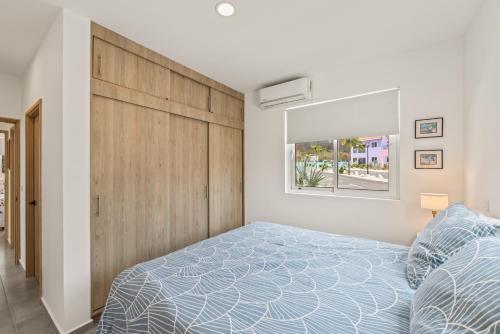 a bedroom with a bed and a large wooden headboard at Punta Azul 12A ocean resort in Willemstad