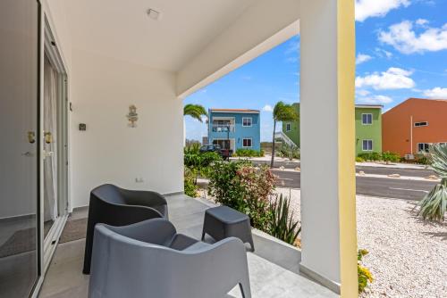 a balcony with chairs and a view of the street at Punta Azul 12A ocean resort in Willemstad