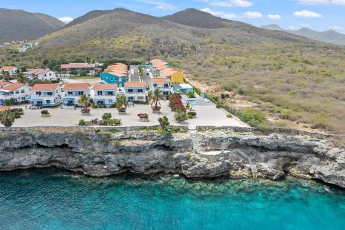 an aerial view of a resort next to the water at Punta Azul 12A ocean resort in Willemstad