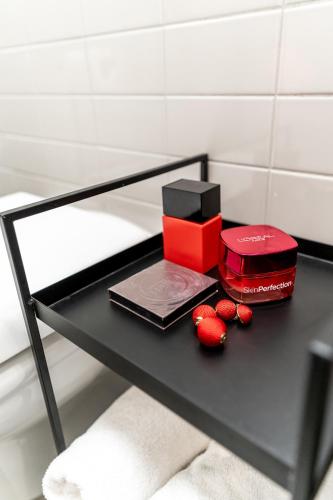 a table with a red box and red balls on it at H11 Aparthotel in Kraków