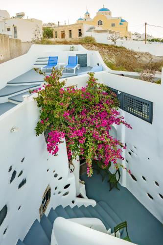 a balcony with flowers on a house at Alba Caverns in Fira