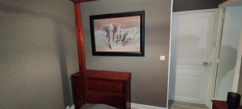 a room with a dresser and a picture on the wall at Villa Mon Repos 3 in La Bourboule