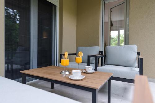 a living room with a coffee table and a chair at Vila Dara in Vrnjačka Banja