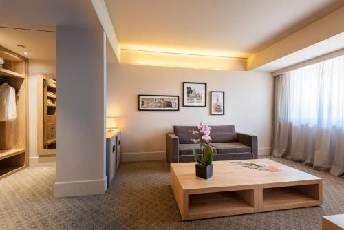 a living room with a couch and a coffee table at A.Roma Lifestyle Hotel in Rome