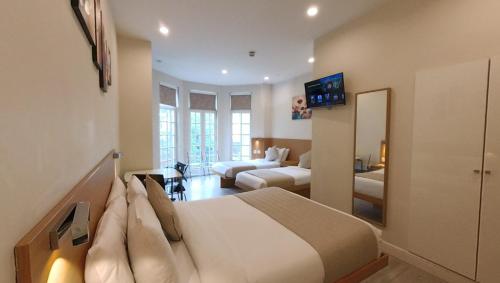 a bedroom with a bed and a living room at NOX Olympia in London