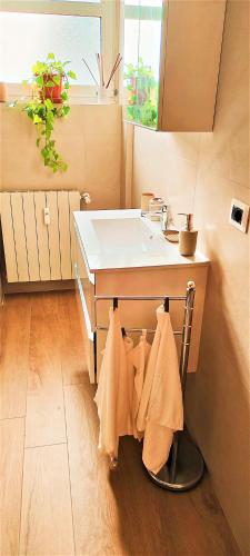 a bathroom with a sink and towels on a counter at Andrea e Sofia Rho Fiera Milano in Rho
