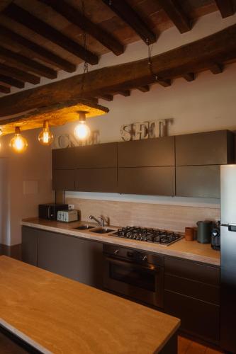 a kitchen with a sink and a stove top oven at Podere la Piscina RestArt in San Casciano dei Bagni