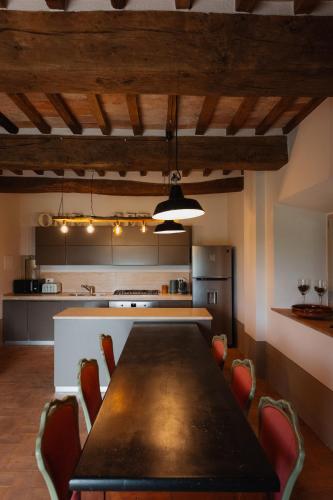 a kitchen with a table and chairs in a room at Podere la Piscina RestArt in San Casciano dei Bagni