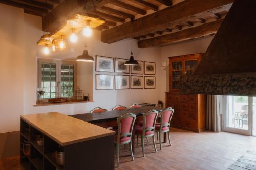 a kitchen with a table and some chairs at Podere la Piscina RestArt in San Casciano dei Bagni