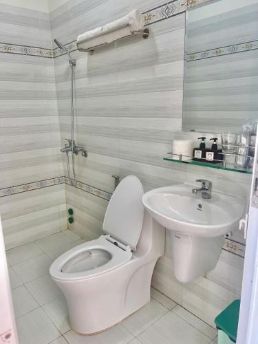 a bathroom with a toilet and a sink at Magnolia Hotel Cam Ranh in Cam Ranh