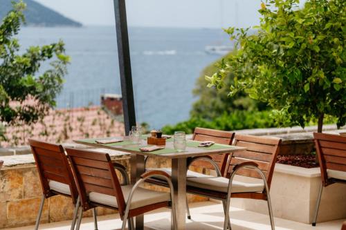 a table and chairs with a view of the ocean at Sun Gardens Dubrovnik in Dubrovnik