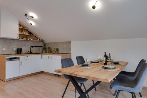 a kitchen and dining room with a wooden table and chairs at Vila Dara in Vrnjačka Banja
