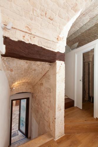 a stone fireplace in a room with a brick wall at Je T'Aime Via G Valentino in Conversano