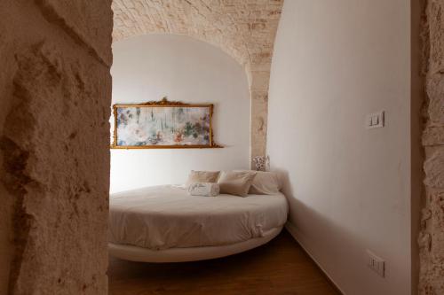 a bedroom with a bed in a white room at Je T'Aime Via G Valentino in Conversano