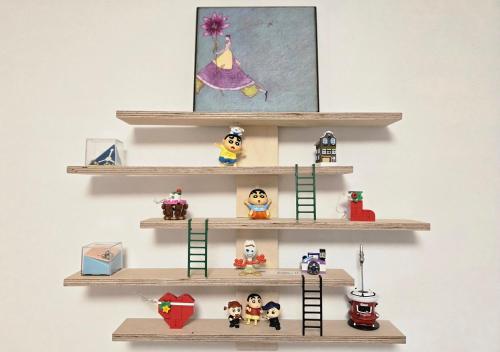 a group of lego figurines on shelves on a wall at Guesthouse Jaysory 수원 행궁 in Suwon