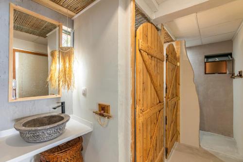 a bathroom with a sink and a wooden door at Villa Zoi in Sissi